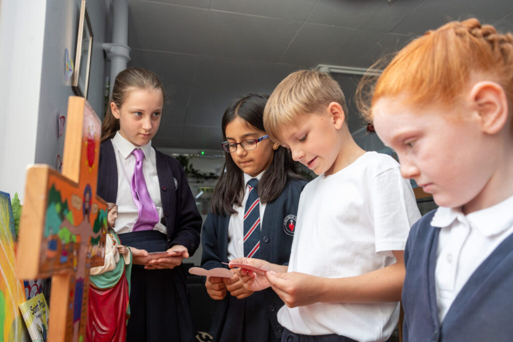 a picture of students around a cross