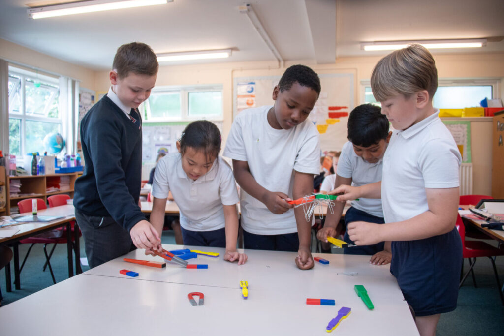 a picture of students playing with magnets