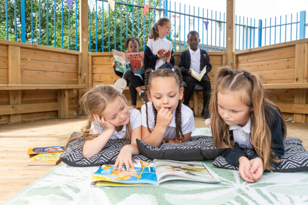 a picture of students reading books in the hut