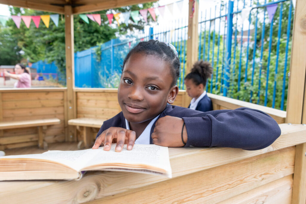 a picture of a student reading a book in the shack